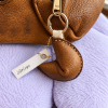 light brown leather fortune cookie keyring and bag charm attached to handbag