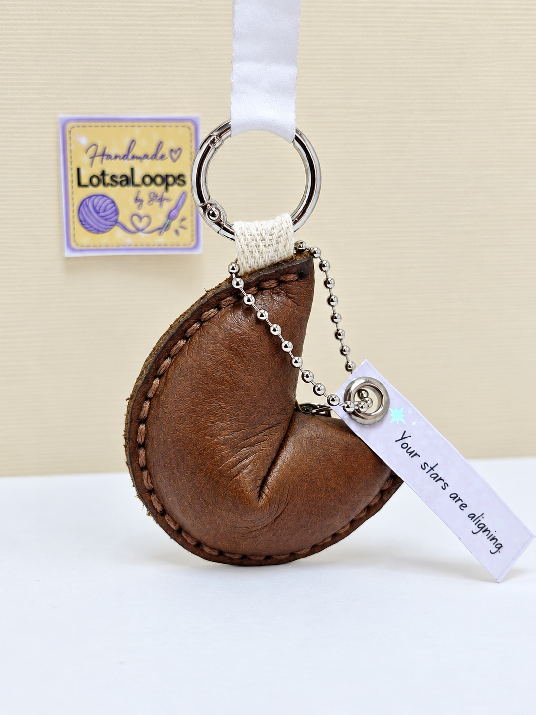 Dark brown handmade leather fortune cookie keyring with removable sparkly fortune