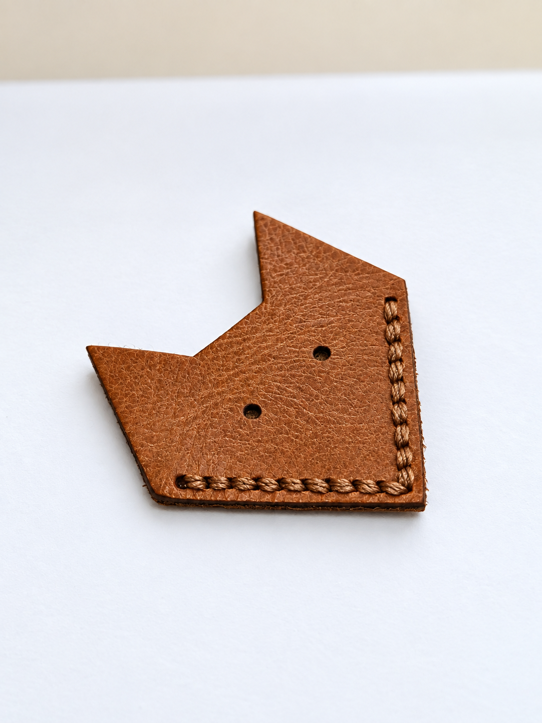 Handmade leather fox corner bookmark with cut-out eyes and hand-stitched edging