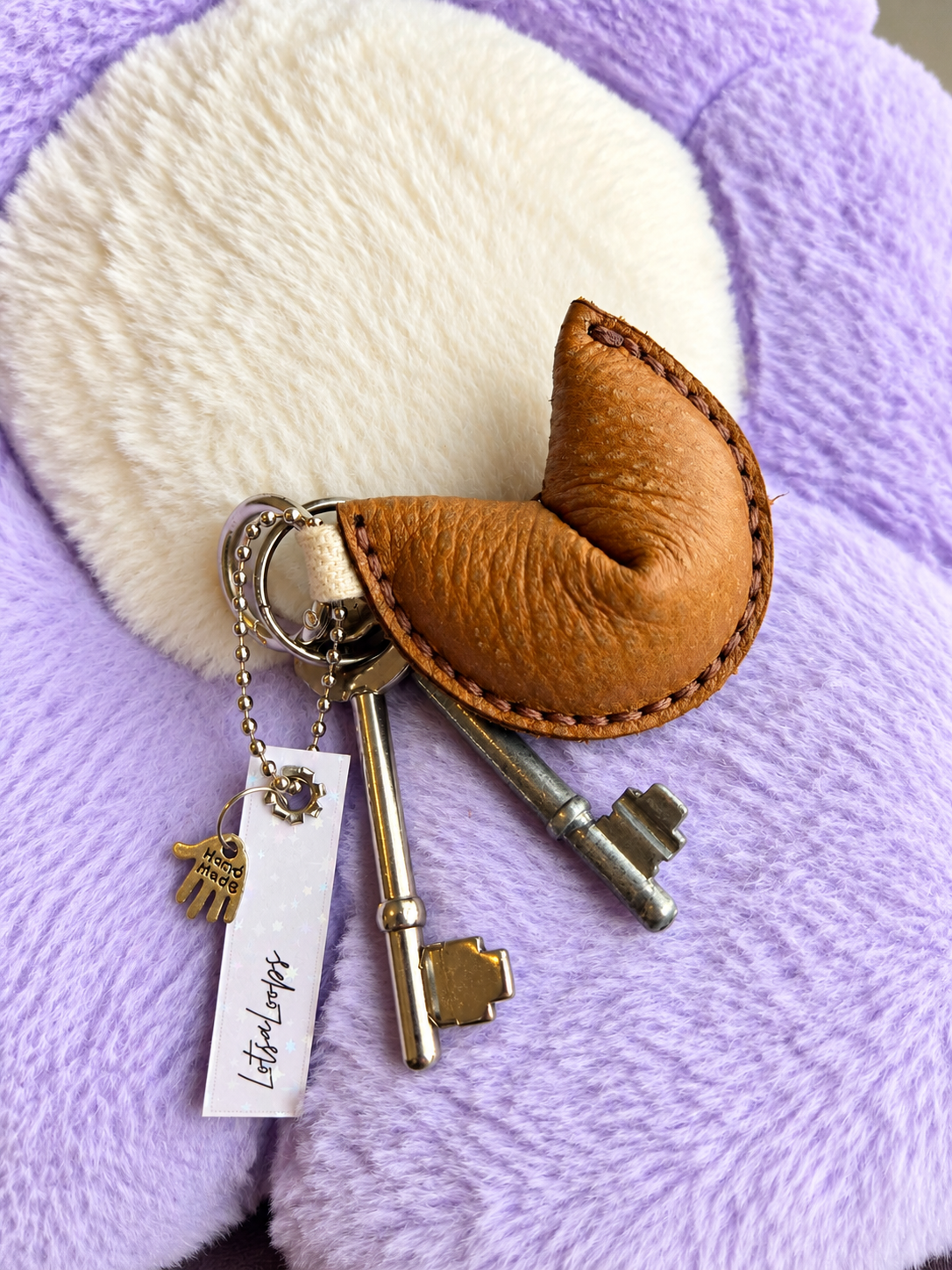 Light brown leather fortune cookie keyring attached to keys